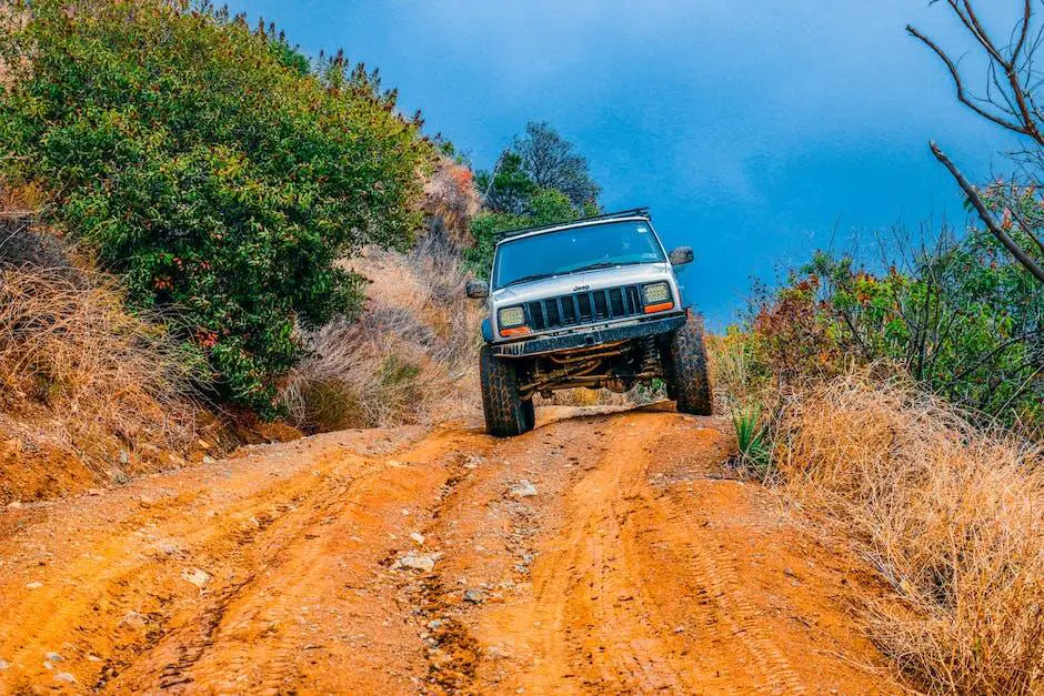 A person removing a door from a Jeep. The door is being lifted off with the help of a door removal tool.