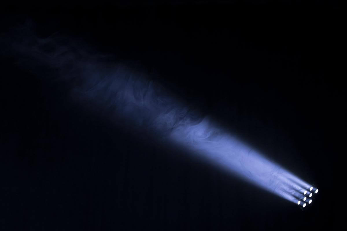 An image of a spotlight shining on a theater stage.