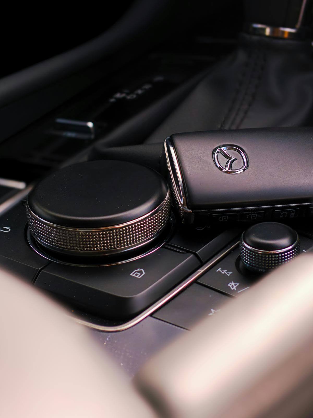 An image showing a person using a key fob to remotely start their car.